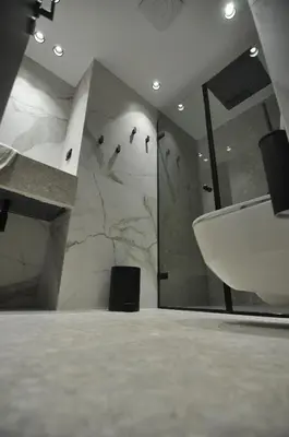 a bathroom with a white sink and a shower at Athinaion Recreation Suites in Athens