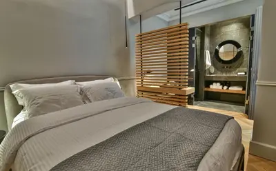 a bedroom with a large bed and a mirror at Athens Dom Hotel in Athens
