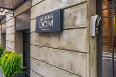 a sign on the side of a building at Athens Dom Hotel in Athens