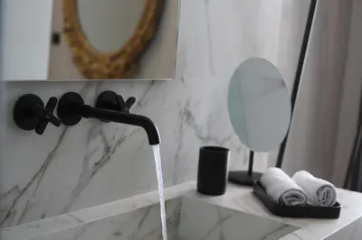 a bathroom sink with water coming out of a faucet at Athens Dom Hotel in Athens