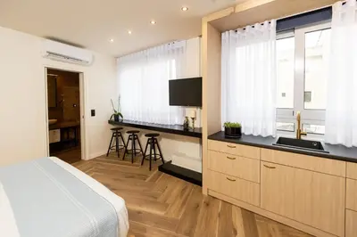 a bedroom with a bed and a kitchen with a sink at Triple A - Between 3 Squares - Monastiraki & Syntagma & Psiry - FREE Parking! in Athens