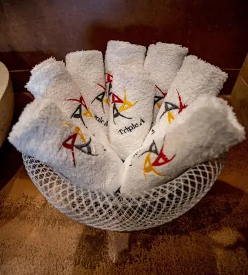 a white bowl filled with white towels with birds on them at Triple A - Between 3 Squares - Monastiraki & Syntagma & Psiry - FREE Parking! in Athens