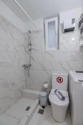 a bathroom with a toilet and a walk in shower at Paleo Faliro Gardenbay in Athens