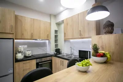 a kitchen with a table with a bowl of fruit on it at Semeli by Heloni Apartments in Athens