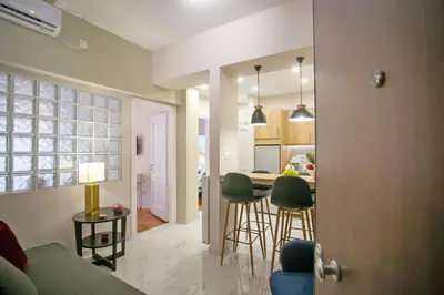 a living room and kitchen with a table and chairs at Semeli by Heloni Apartments in Athens