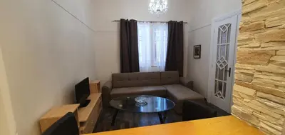 a living room with a couch and a table at Beauty of Central Athens 60sqm in Athens