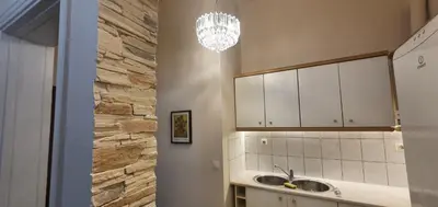 a kitchen with a sink and a stone wall at Beauty of Central Athens 60sqm in Athens
