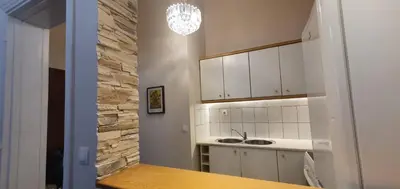 a kitchen with white cabinets and a sink at Beauty of Central Athens 60sqm in Athens