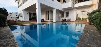 a swimming pool in front of a building at Athenian Luxury Villa in Glyfada in Athens