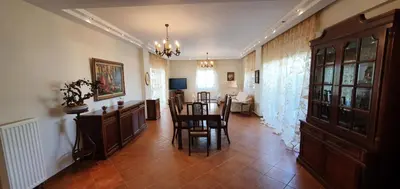 a dining room with a table and chairs in a room at Athenian Luxury Villa in Glyfada in Athens