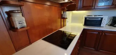a kitchen with a stove top oven next to a microwave at Athenian Luxury Villa in Glyfada in Athens