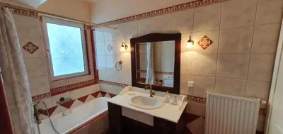 a bathroom with a sink and a bath tub at Athenian Luxury Villa in Glyfada in Athens