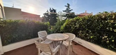 a table and chairs sitting on a balcony at Athenian Luxury Villa in Glyfada in Athens