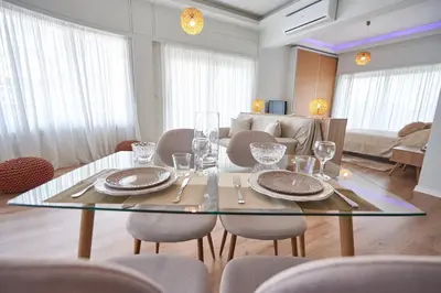 a dining room with a glass table and chairs at The EL GRECO spirit meets the Athenian luxury Apt1 in Athens
