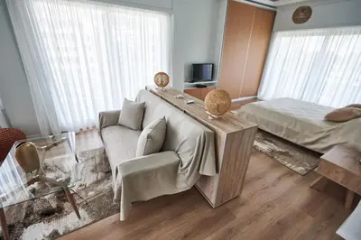 a living room with a couch and a table and a bed at The EL GRECO spirit meets the Athenian luxury Apt1 in Athens