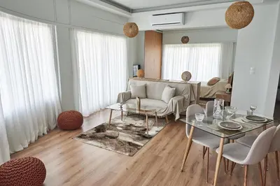 a living room with a couch and a table and chairs at The EL GRECO spirit meets the Athenian luxury Apt1 in Athens