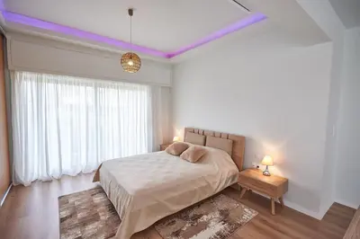 a bedroom with a bed with purple lights on the ceilings at The EL GRECO spirit meets the Athenian luxury Apt1 in Athens