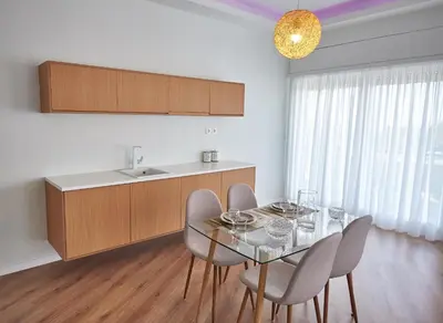 a kitchen with a glass table with chairs and a sink at The EL GRECO spirit meets the Athenian luxury Apt1 in Athens