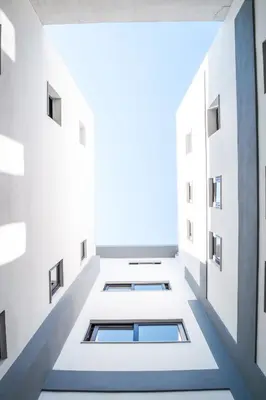 an empty corridor in a building with windows at Iasonos Suites Athens in Athens