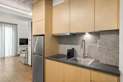 a kitchen with a sink and a refrigerator at ATHENIAN VIEW LOFT in Athens