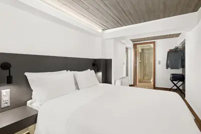 a bedroom with a white bed and a wooden ceiling at ATHENIAN VIEW LOFT in Athens