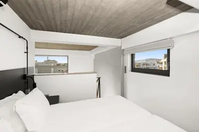 a bedroom with a white bed and a window at ATHENIAN VIEW LOFT in Athens