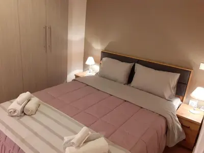 a bedroom with a large bed with towels on it at Katsanis luxury apt., stunning view of acropolis in Athens