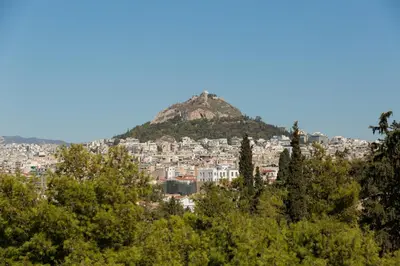 a city on top of a hill with trees at Katsanis luxury apt., stunning view of acropolis in Athens