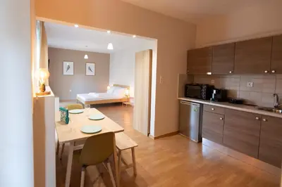 a kitchen and dining room with a table and a room at The brand new House meets the ideal location Apt1 in Athens