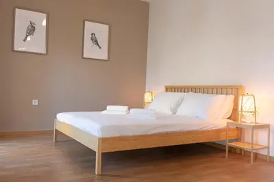 a bedroom with a large bed with white sheets at The brand new House meets the ideal location Apt1 in Athens