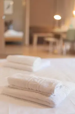three towels sitting on top of a table at The brand new House meets the ideal location Apt1 in Athens