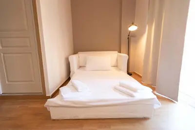 a white bed in a room with two towels on it at The brand new House meets the ideal location Apt1 in Athens