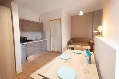 a small apartment with a table and a kitchen at The brand new House meets the ideal location Apt1 in Athens