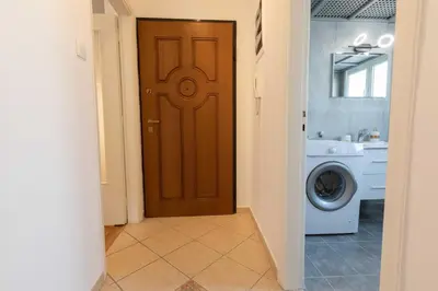 a hallway with a brown door and a washing machine at Athenian Port Luxury Apartment 1/Piraeus Riviera in Piraeus