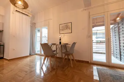 a dining room with a table and chairs in it at Athenian Port Luxury Apartment 1/Piraeus Riviera in Piraeus