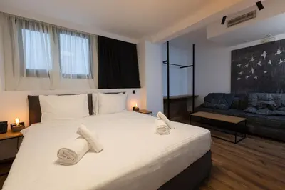 a bedroom with a large bed with towels on it at The Fountain Athens in Athens
