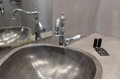 a sink in a bathroom with a faucet at The Fountain Athens in Athens