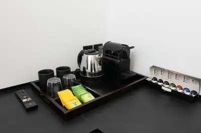 a coffee station with a coffee maker and a coffee pot at The Fountain Athens in Athens