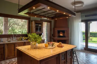 a kitchen with a large island with a fireplace at Villa Terra Mare in Vari
