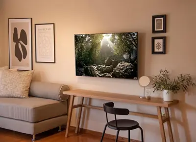 a living room with a couch and a tv on the wall at Villa Terra Mare in Vari