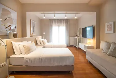 a large bedroom with two beds and a couch at Villa Terra Mare in Vari