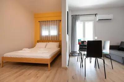 a bedroom with a bed and a table and chairs at The brand new House meets the ideal location Apt2 in Athens
