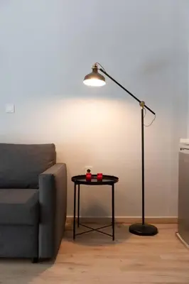 a lamp sitting next to a couch and a table at The brand new House meets the ideal location Apt2 in Athens