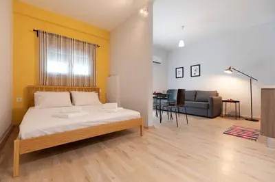 a bedroom with a bed and a living room at The brand new House meets the ideal location Apt2 in Athens