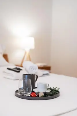 a tray with a cup and a glass on a table at Two bedroom Apt in Syntagma - Ermou area in Athens