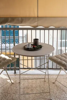 a table with a plate of food on a balcony at Two bedroom Apt in Syntagma - Ermou area in Athens