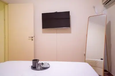 a room with a mirror and a tv on the wall at Two bedroom Apt in Syntagma - Ermou area in Athens