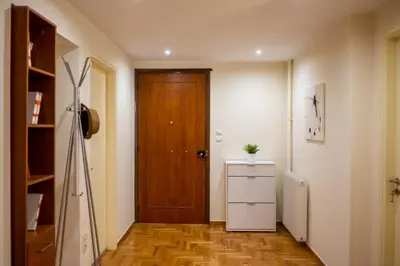 a hallway with a door and a dresser in a room at Two bedroom Apt in Syntagma - Ermou area in Athens