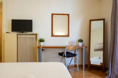 a bedroom with a desk with a television and a mirror at Two bedroom Apt in Syntagma - Ermou area in Athens