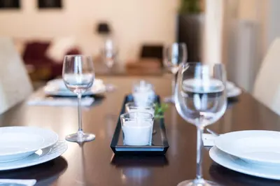 a table with wine glasses and plates on it at Two bedroom Apt in Syntagma - Ermou area in Athens